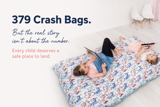 Two children relaxing on a Sensory Super Heroes Crash Bag with the message 379 Crash Bags and every child deserves a safe place to land